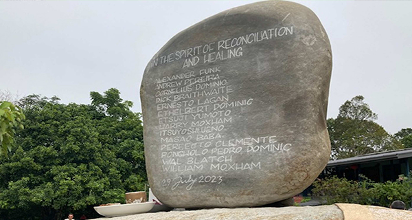 Large stone monument with engraved names under the title 
