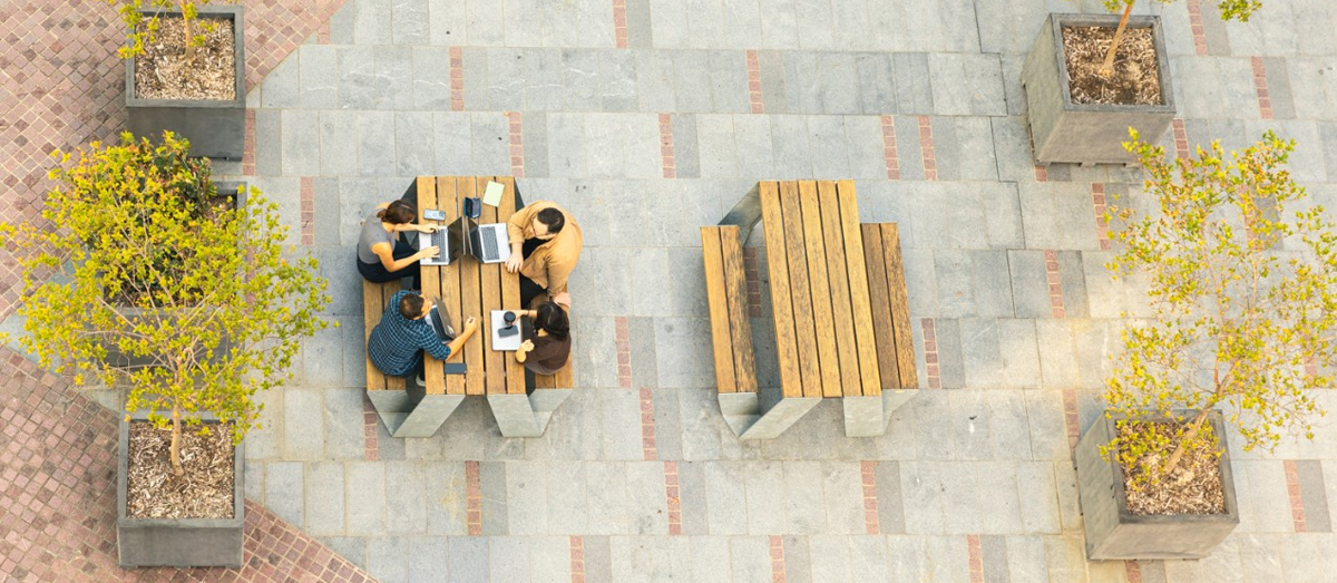Students sitting outside on tables