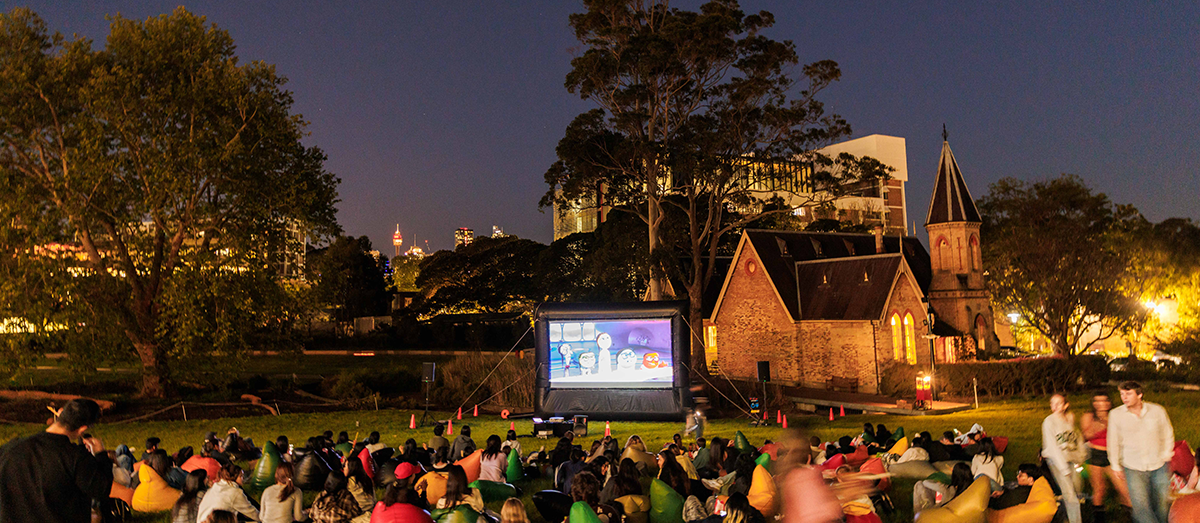 Open air cinema at Cadigal Green with students watching on bean bags
