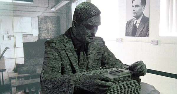A statue of a person looking at a box