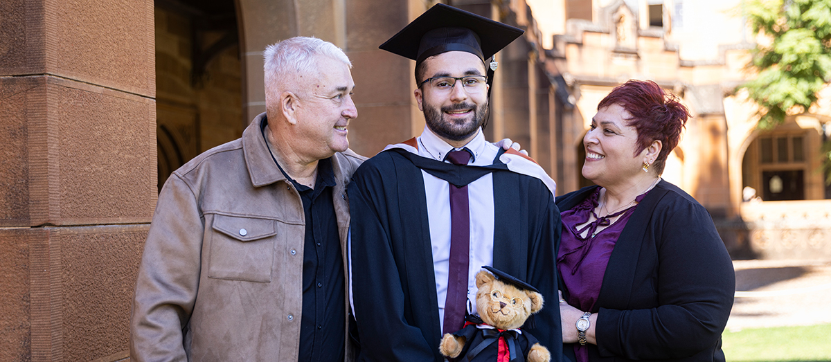 MySydney Scholarship recipient Stephen Bursic celebrates graduation day with his mother and father.