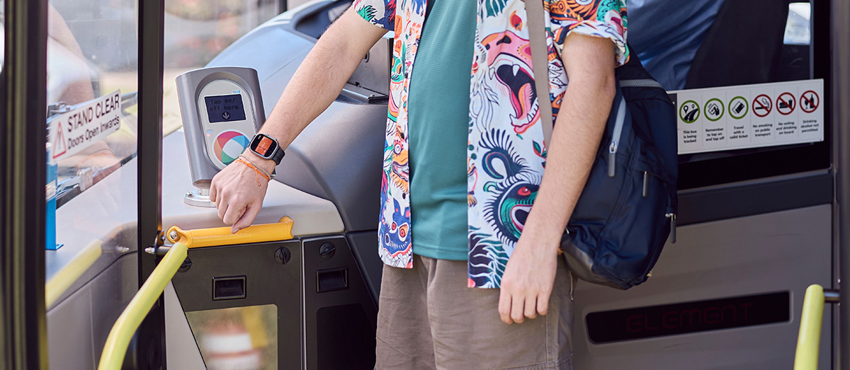 Student using watch to tap on to a bus