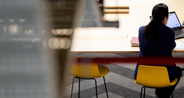 Student sitting at desk with laptop of in front of them