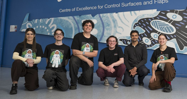 Noah and the eight students selected for the program
