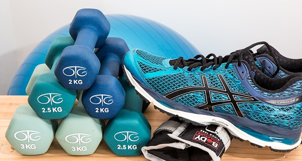 Shoes and weights with an exercise ball in background