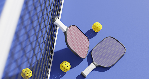 Pickleball paddles and balls on court