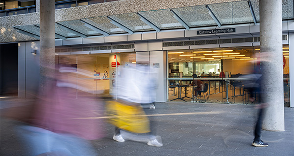 Students walking past Carslaw Learning Hub West
