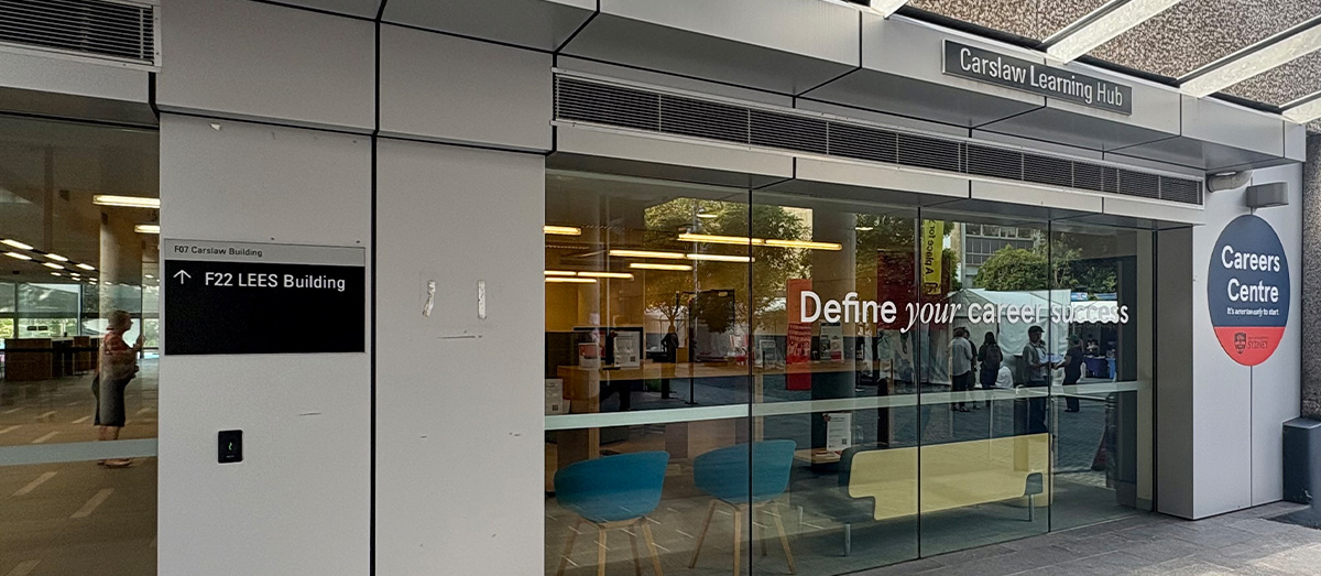 Building with large glass windows that have 'Define your career success' in white lettering