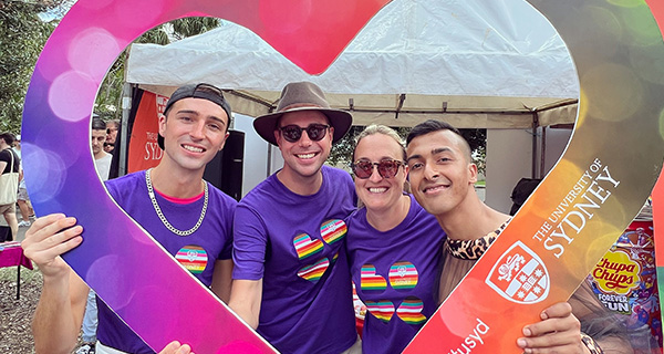 People holding a University of Sydney heart for Mardi Gras