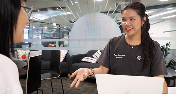 A Peer Support Advisor chatting with a student