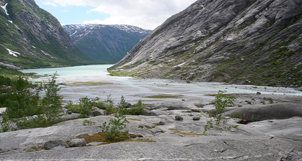 A glacier with mountains in the distance