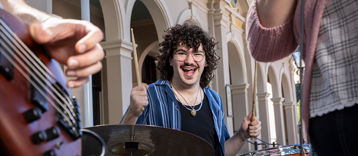 Fourth-year student Max playing the drums