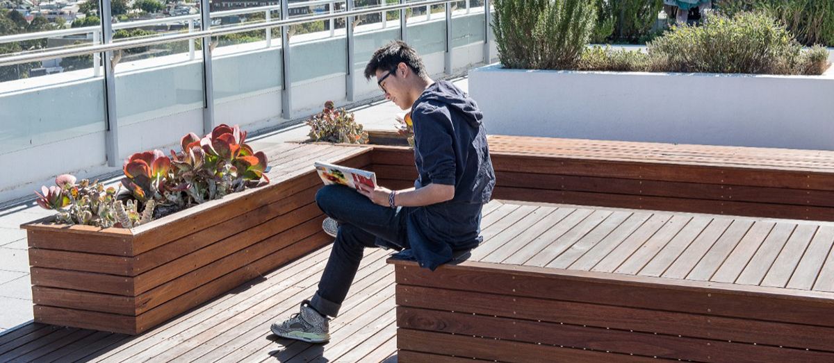 Student on Fisher Library rooftop