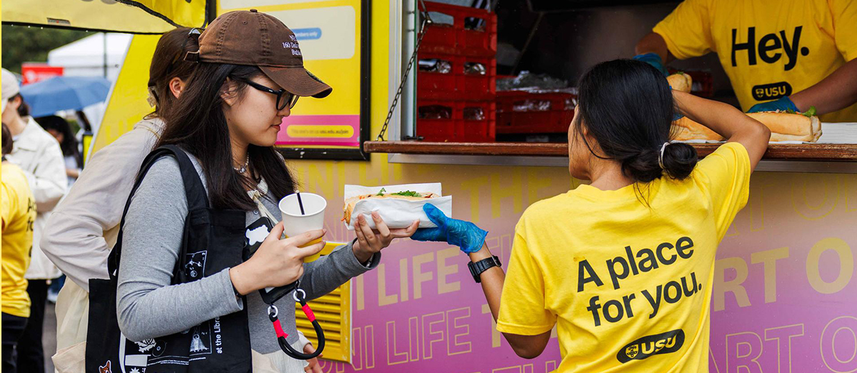 A student obtaining food from USUeats