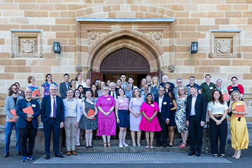 A large group of people in front of the Great Hall