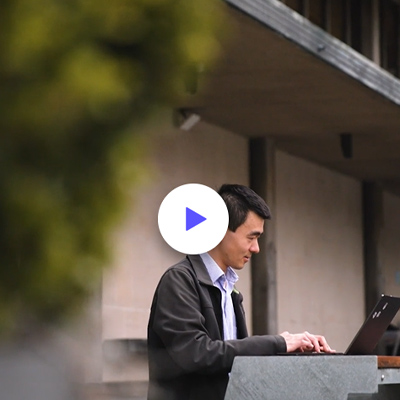 Danny Liu using a laptop outside