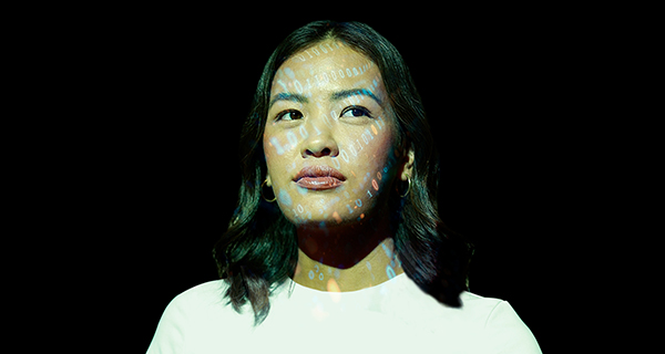 A student with numbers projected onto their face