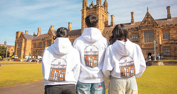 Students wearing the hoodie, facing The Quad