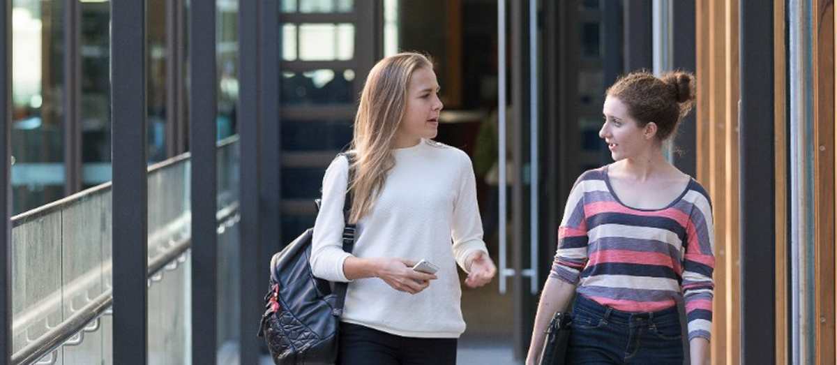 Students walking in front of Belinda Hutchinson Building