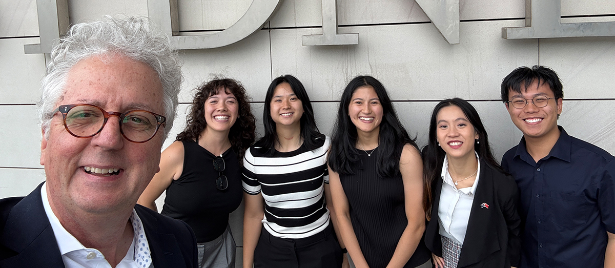 Five students smiling for a selfie with Vice-Chancellor Mark Scott