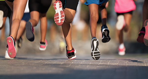 close up of shoes of people running
