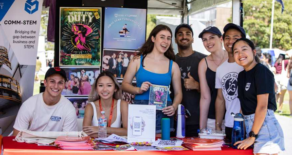 A group of students at a Welcome Fest stall, promoting COMM-STEM