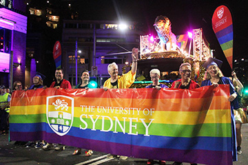Academics holding a rainbow University of Sydney banner